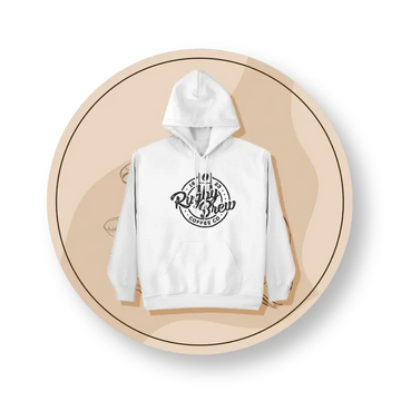 A white pullover rugby hoodie with a black circular graphic on the chest reading 'Rugby Brew Coffee Co', displayed on a beige circular graphic background.